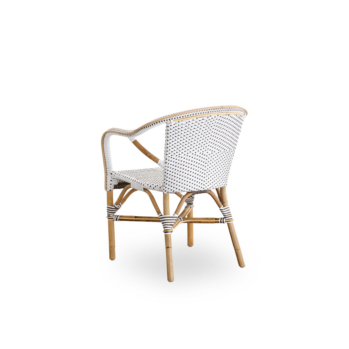 Back side view of the Madeleine dining armchair.
Rattan frame with seat and backrest woven with ArtFibre in white with brown dots. Inspired by 1950s bistro design.