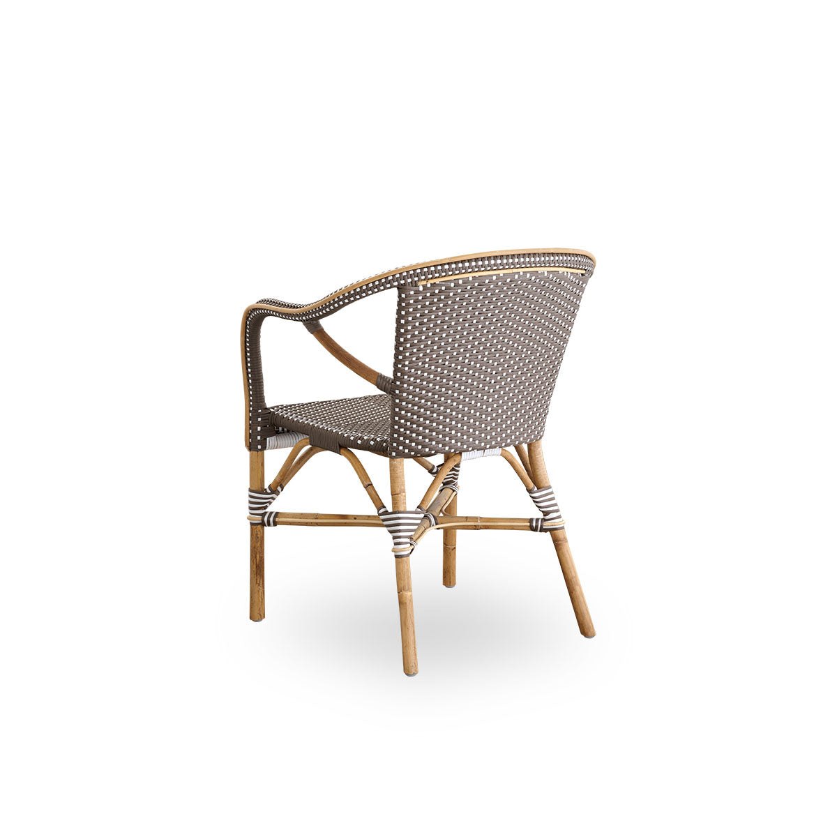 Back side view of the Madeleine dining armchair.
Rattan frame with seat and backrest woven with ArtFibre in brown with white dots. Inspired by 1950s bistro design.