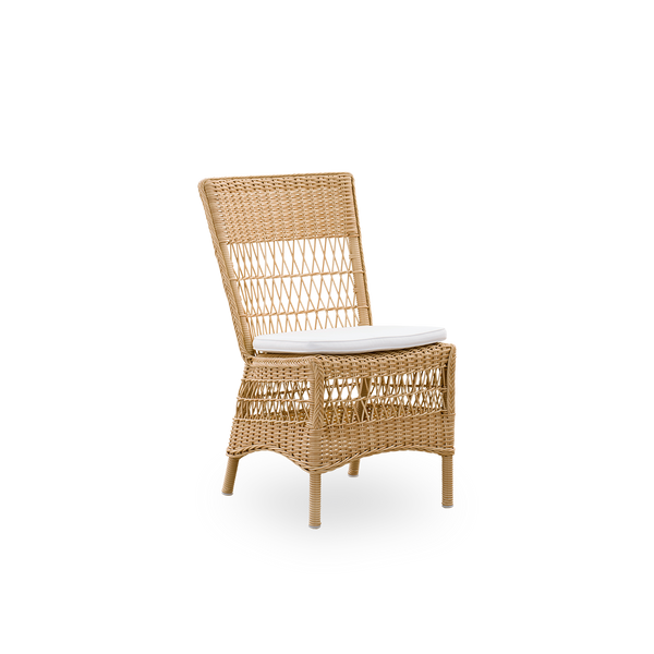 Side view of Marie outdoor dining chair presented in Natural color. Aluminum frame fully woven with ArtFibre inspired by British colonial style.