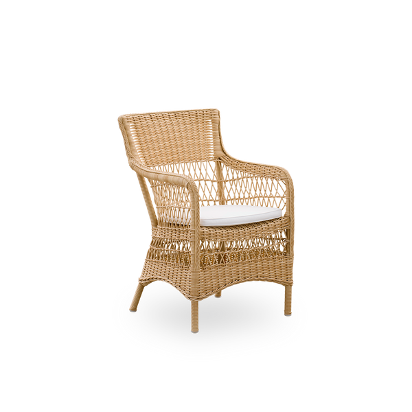 Side view of Marie outdoor dining chair with armrests presented in Natural color. Aluminum frame fully woven with ArtFibre inspired by British colonial style.