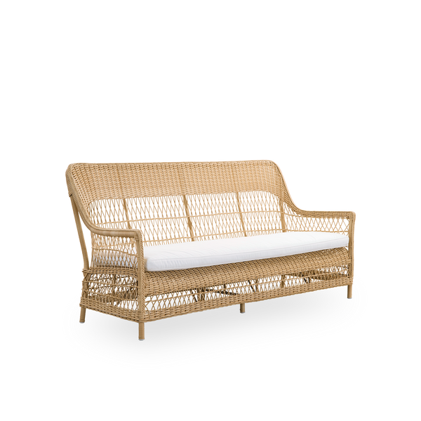 Side view of the Dawn outdoor 3-seater sofa in natural color, inspired by British colonial style. Romantic sofa with armrest and a high backrest. Fully woven ArtFibre on hand-bent aluminum frame.