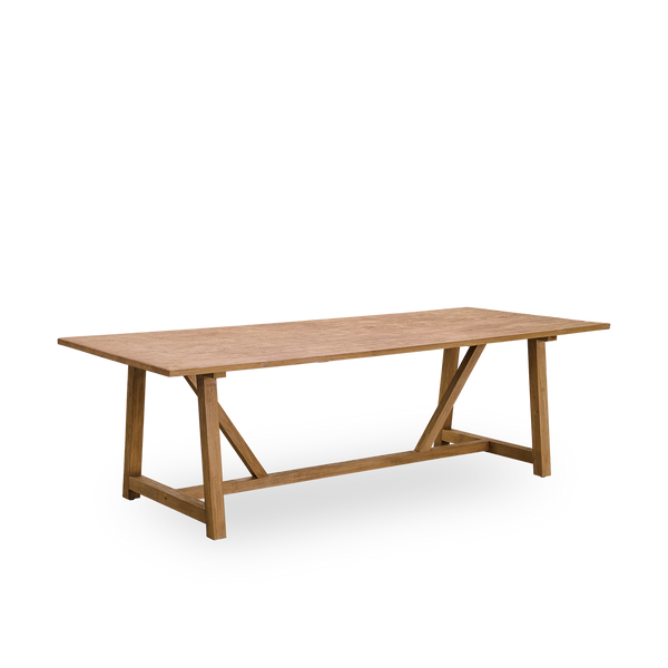 Side view of Lucas indoor dining table in patinated teak with a rustic, exclusive look in natural chestnut color. Size 240x100 cm for 8 persons.
