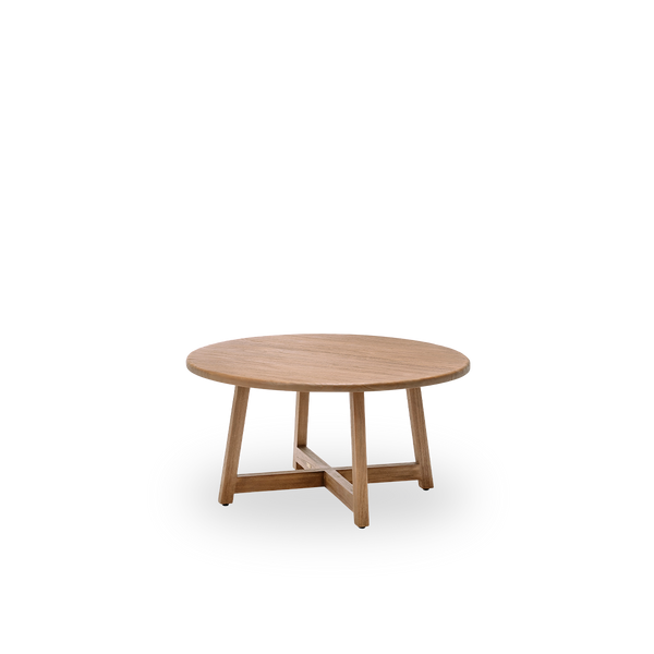 Side view of the Aksel coffee table, Ø100 cm, in teak with a natural, patinated surface. Surface treated to bring out the natural grain of the wood, with a charming rustic look. Made from teak certified as Indonesian Legal Wood.