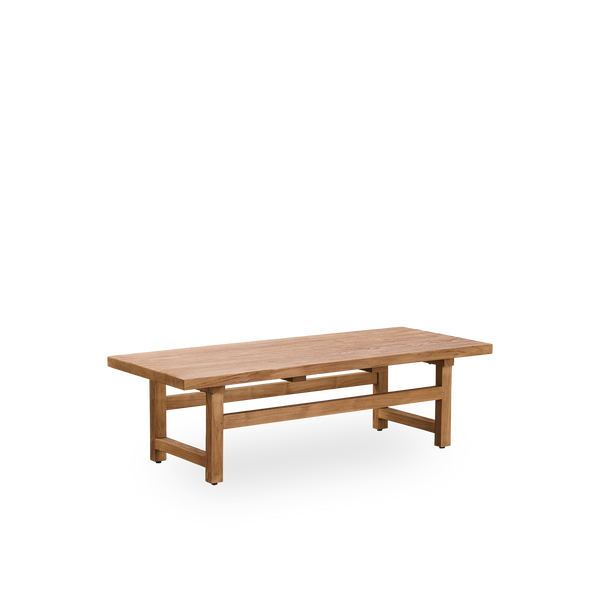Side view of Alfred coffee table, 140x55 cm, is crafted from Indonesian legal wood, with patinated teak, rustic finish, showcasing natural wood and solid design. 