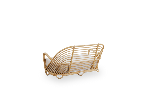 Back side view of the Charlottenborg 2-seater sofa in polished natural rattan, designed by Arne Jacobsen. The sofa features a curved back and armrests integrated into the base, handcrafted from high-quality Indonesian rattan.