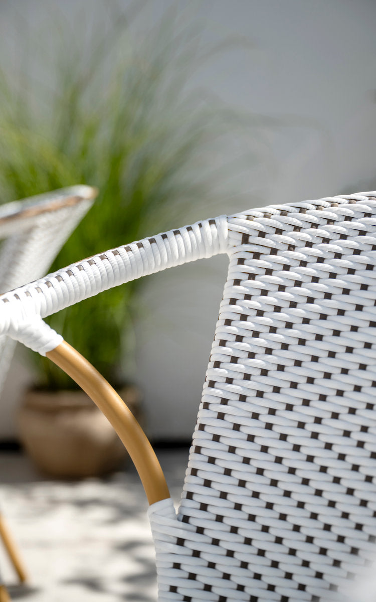 This is a close-up image of Madeleine Exterior Dining Chair in almond aluminium frame white w cappuccino dot artfibre. Woven backrest and armrest.