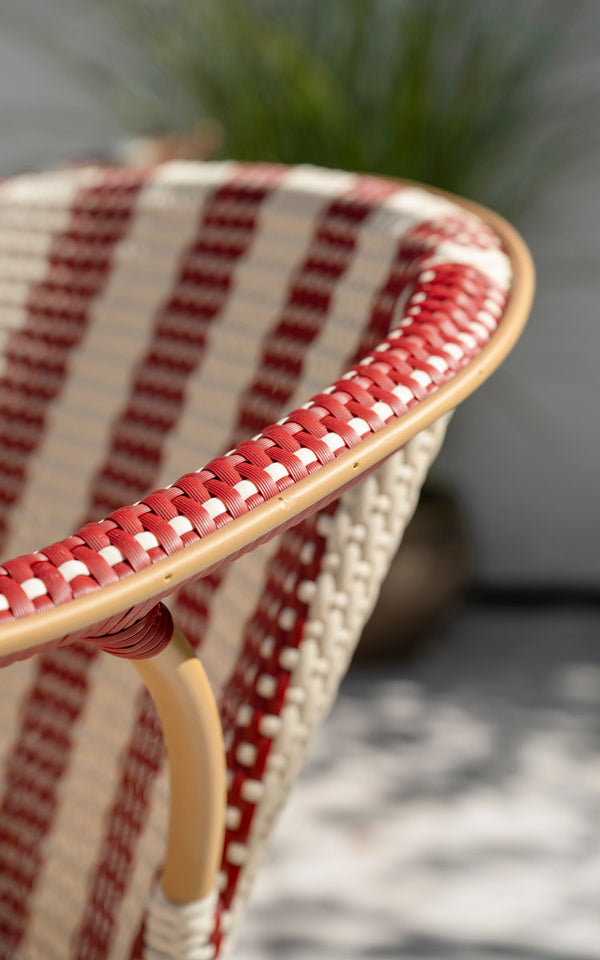 This is a close-up image of Madeleine Exterior Dining Chair in almond aluminum frame striped ivory burgundy. Striped weave, burgundy binding.