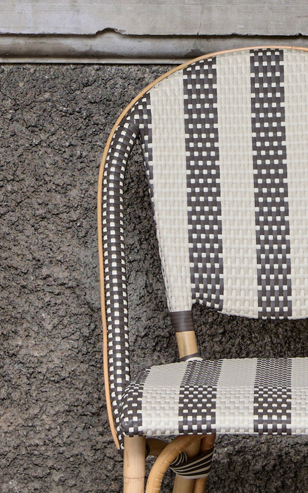 This is a close-up image of Sofie Dining Chair in striped cappuccino ivory artfibre skin on natual rattan frame.