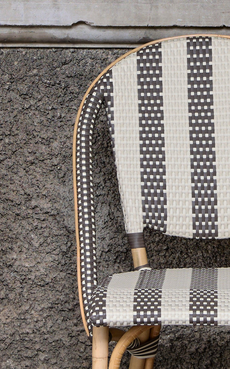 This is a close-up image of Sofie Dining Chair in striped cappuccino ivory artfibre skin on natual rattan frame.