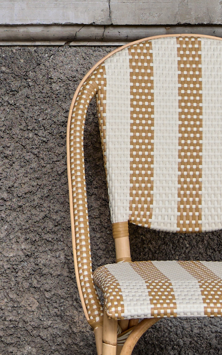 This is a close-up image of Sofie Dining Chair in striped honey ivory artfibre skin on natual rattan frame.