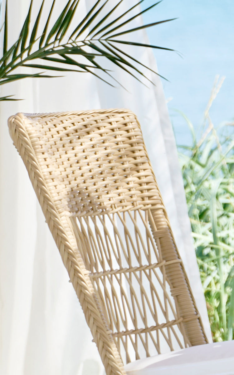 This is a close-up image of Marie Exterior Side Chair in natural artfibre aluminium. Detail of the cross-lattice weave and seat edge.