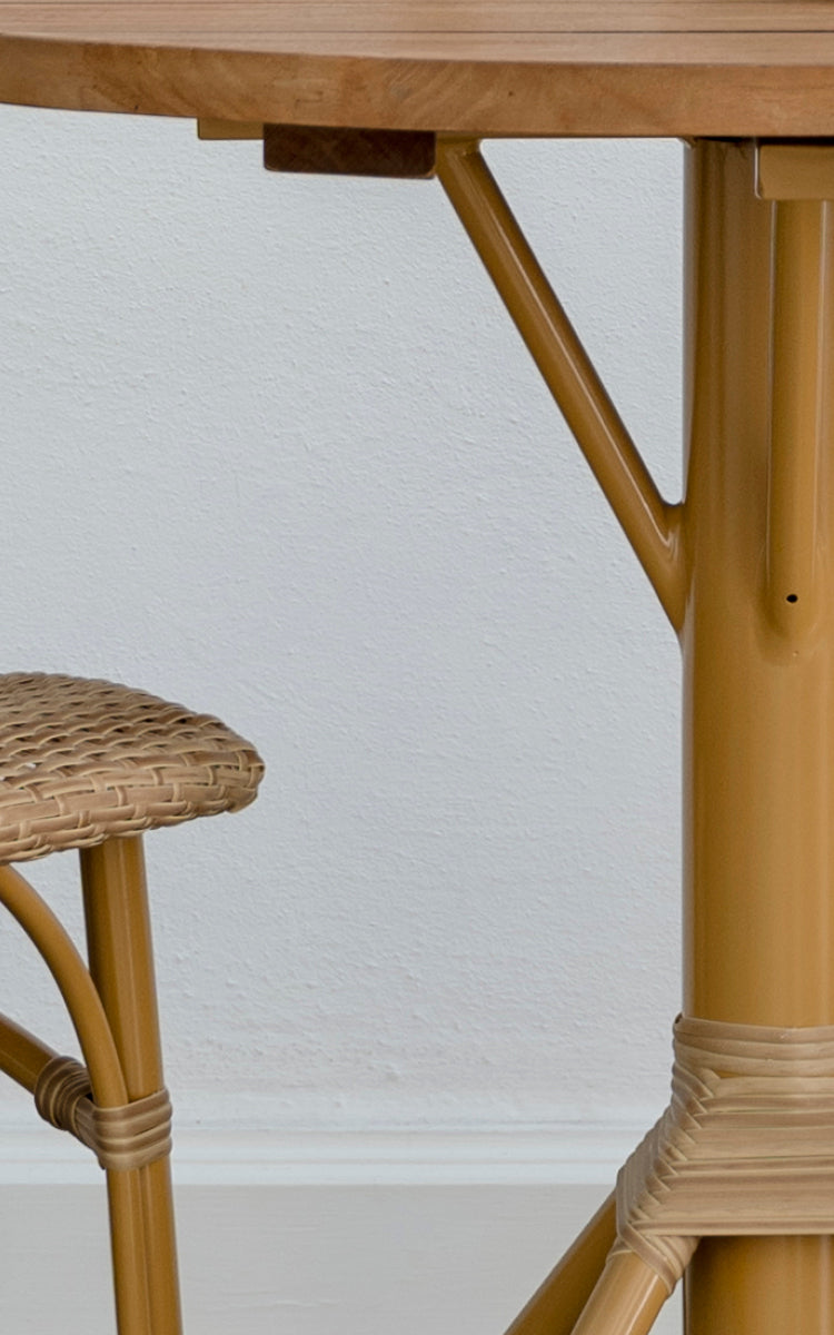 This is a close-up image of Nicole Cafe Table in almond aluminium frame natural ArtFibre. Detail of the teak top and base wrap.