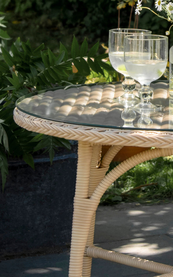 This is a close-up image of Victoria Exterior Coffee Table Ø80 cm in natural artfibre aluminium. Detail of the woven texture and frame construction.