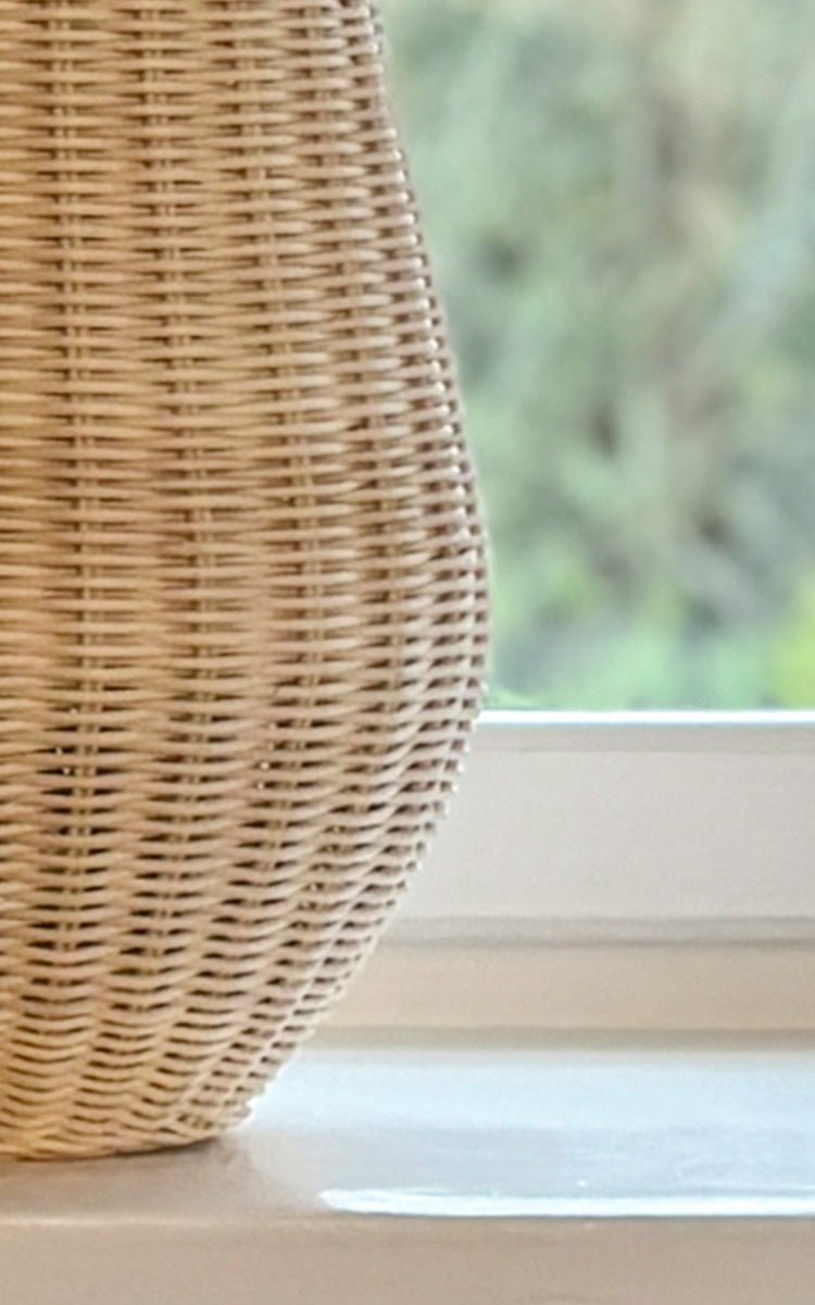 This is a close-up image of Aura Basket in natural core weave Iron frame.