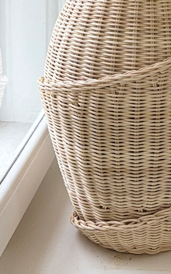 This is a close-up image of Floris Basket in natural core weave iron frame.