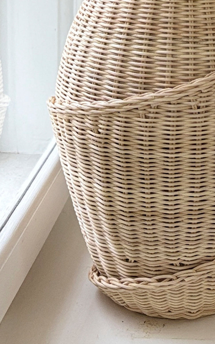 This is a close-up image of Floris Basket in natural core weave iron frame.