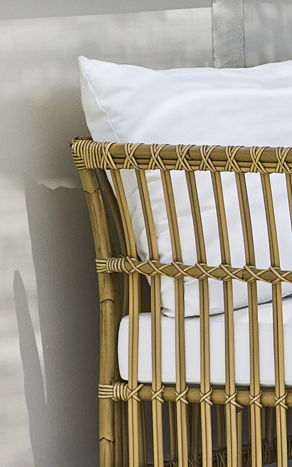 This is a close-up image of Maggie Sofa Corner Module in antique aluminium artfibre. Vertical slat frame with wrapped joints and white cushion.