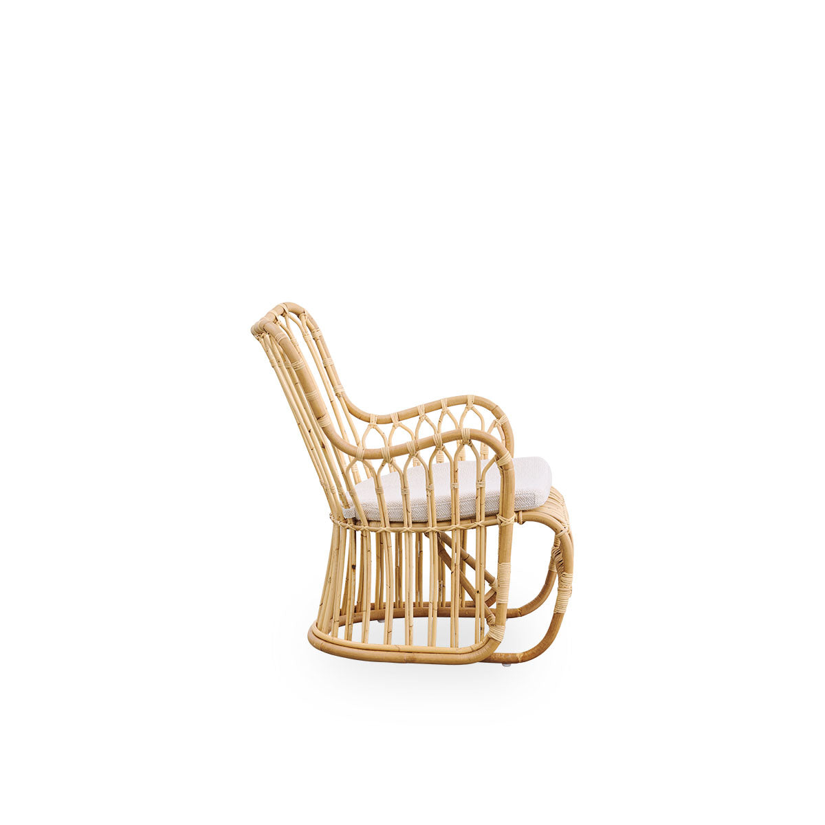 Plain side view of Tulip lounge chair designed by Tove Kindt-Larsen, with soft organic lines. Handcrafted from high-quality Indonesian rattan