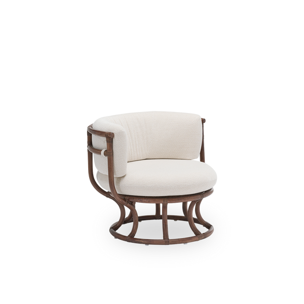 Side view of the Coco lounge chair with seat and back cushions, in brown rattan. Designed by Nanna Ditzel in 1973 and based on perfect circles and half circles. Handcrafted from premium Indonesian rattan.