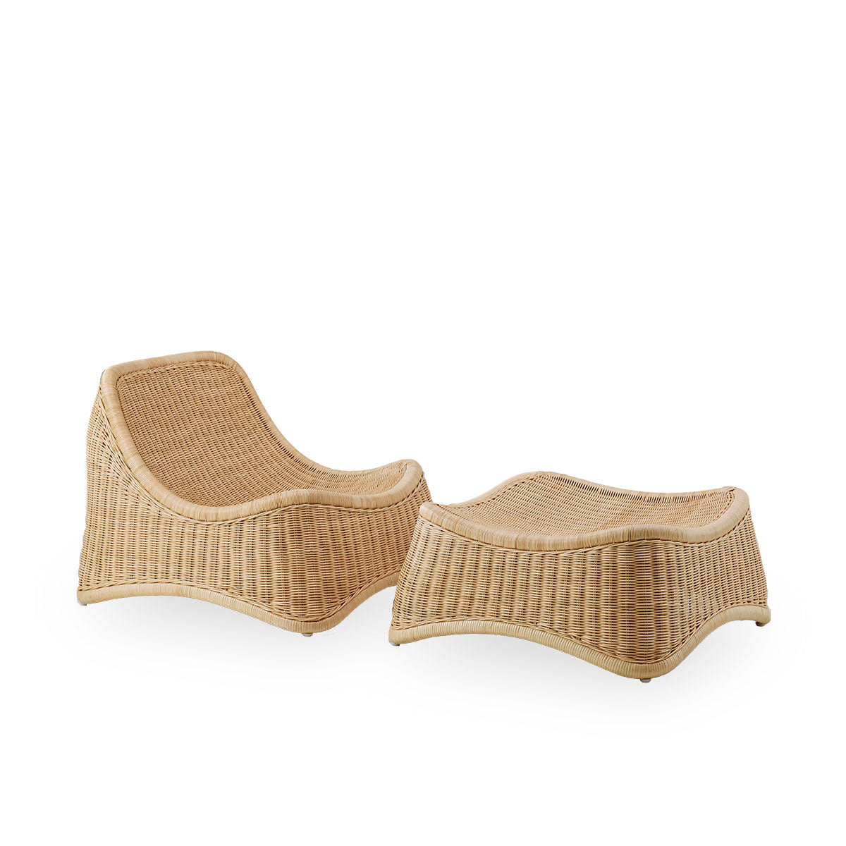Side view of Chill Exterior lounge chair, a fully woven outdoor chair with a matching footstool designed by Nanna Ditzel. The chair has no armrests and is handcrafted from high quality Indonesian rattan.