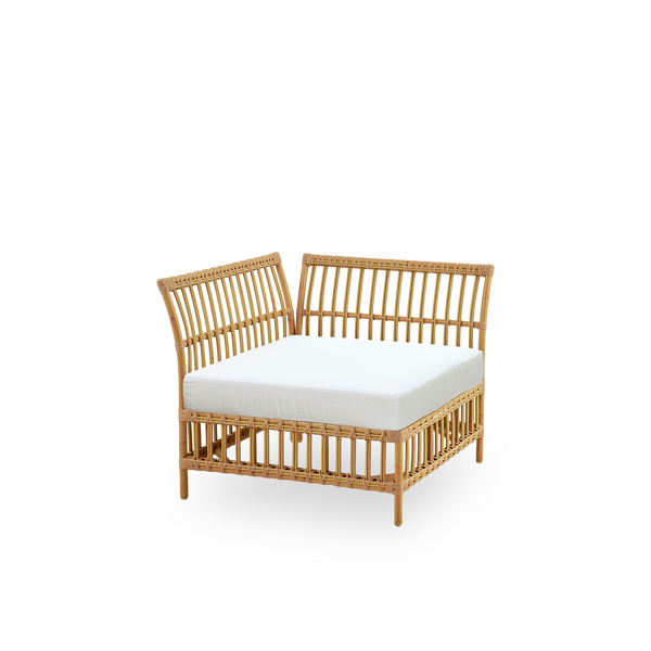 Side view of Maggie outdoor sofa corner module in Natural color presented with white seat and back cushion. Aluminium frame with handpainted rattan look with ArtFibre windings.