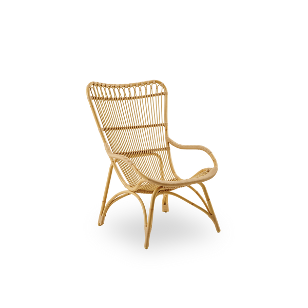Side view of Monet outdoor lounge chair with high backrest and armrests presented in Natural color. Aluminium frame in rattan look with ArtFibre windings.