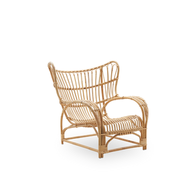 Side view of Teddy lounge chair by Viggo Boesen, big embracing lounge chair inspired by the 19th-century wing chair. Handcrafted from high quality Indonesian rattan