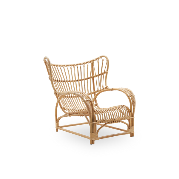 Side view of Teddy lounge chair by Viggo Boesen, big embracing lounge chair inspired by the 19th-century wing chair. Handcrafted from high quality Indonesian rattan