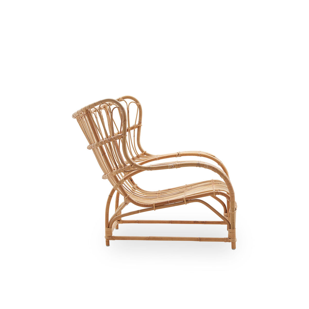 Plain side view of Teddy lounge chair by Viggo Boesen, big embracing lounge chair inspired by the 19th-century wing chair. Handcrafted from high quality Indonesian rattan