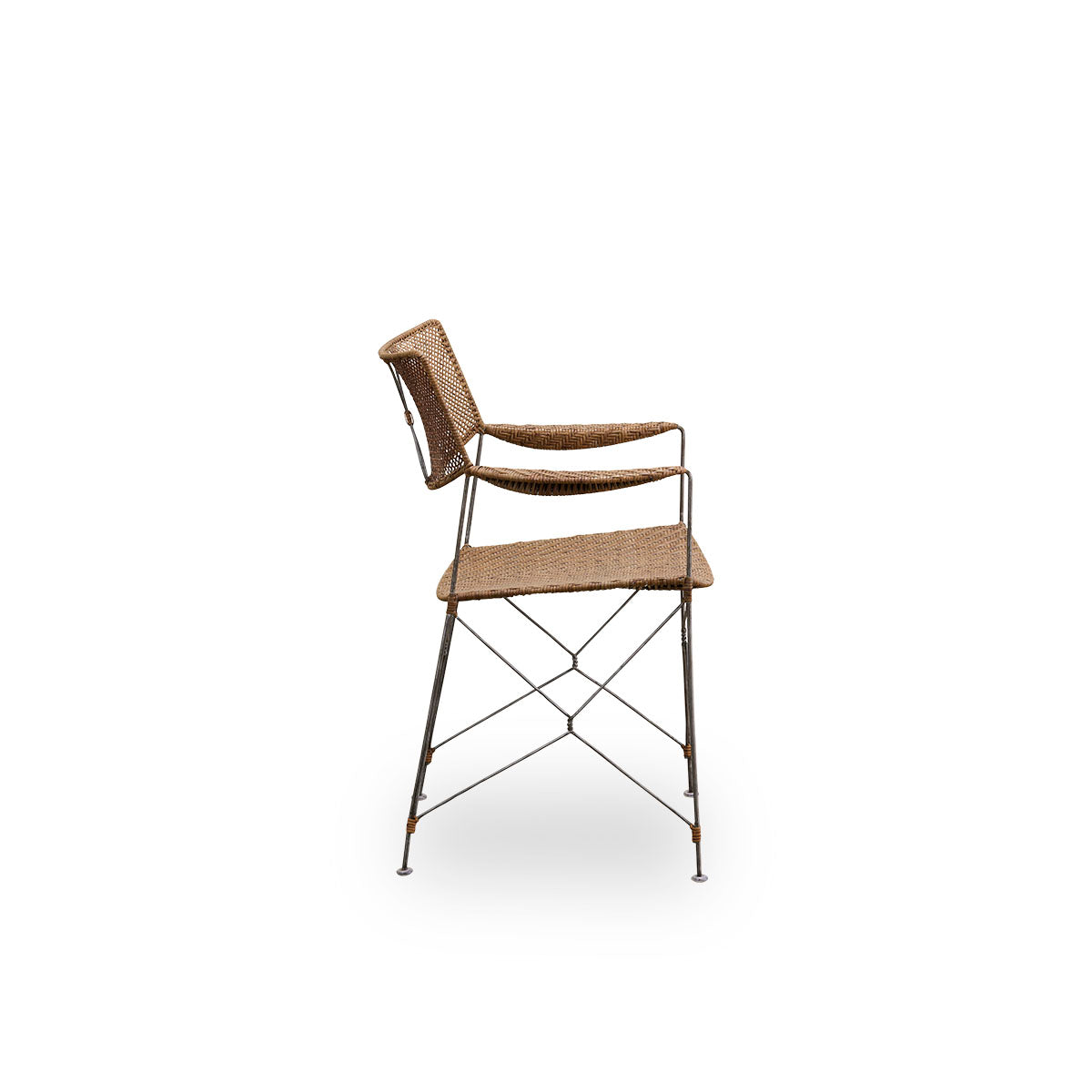 Plain side view of Rap dining chair designed by Yuzuru Yamakawa. Steel frame with seat and backrest handwoven with Indonesian rattan, lightweight chair combining Japanese design with traditional indonesian craftsmanship.